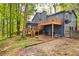 Home's exterior featuring decks, a screened porch, mature trees and a well maintained lawn at 3292 Holly Mill Ct, Marietta, GA 30062