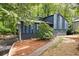 Charming blue two-story home with landscaped yard and inviting entryway, nestled among mature trees at 3292 Holly Mill Ct, Marietta, GA 30062