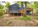 Home's exterior view featuring a deck, screened in porch, and a lush backyard at 3292 Holly Mill Ct, Marietta, GA 30062