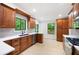 Kitchen with wood cabinets, stainless steel appliances, white countertops, and a large window overlooking greenery at 3292 Holly Mill Ct, Marietta, GA 30062