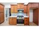 Kitchen features stainless steel gas range, subway tile backsplash, and rich wood cabinetry at 3292 Holly Mill Ct, Marietta, GA 30062
