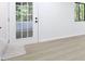 Room with wood look floors and natural light filtering in through the door and windows at 3292 Holly Mill Ct, Marietta, GA 30062