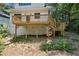 Exterior of home featuring a wood deck, yard space, and basement access at 4642 Orchid Dr, Pine Lake, GA 30072
