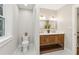 Bright bathroom featuring a rustic wood vanity with double sinks and modern lighting at 4642 Orchid Dr, Pine Lake, GA 30072