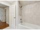 Elegant bathroom features a white tub with stylish tile surround and brushed gold fixtures at 4642 Orchid Dr, Pine Lake, GA 30072