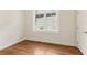 Bright bedroom with hardwood floors and a large window at 4642 Orchid Dr, Pine Lake, GA 30072