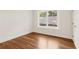 Light-filled bedroom with gleaming hardwood floors and a large window at 4642 Orchid Dr, Pine Lake, GA 30072