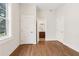 Spacious bedroom with hardwood floors and view of an ensuite bathroom at 4642 Orchid Dr, Pine Lake, GA 30072