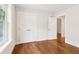 Inviting bedroom features a large window, spacious closet, and hardwood floors at 4642 Orchid Dr, Pine Lake, GA 30072