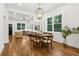 Bright dining room area with hardwood floors that looks toward the living room featuring natural light and neutral colors at 4642 Orchid Dr, Pine Lake, GA 30072