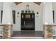 Close-up of the front door featuring a dark wood door, sidelights, and stone accents at 4642 Orchid Dr, Pine Lake, GA 30072
