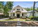 Charming craftsman home featuring a welcoming front porch, stone accents and a well-manicured lawn at 4642 Orchid Dr, Pine Lake, GA 30072