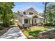 Beautiful craftsman home with a long driveway, lush landscaping, and inviting covered front porch at 4642 Orchid Dr, Pine Lake, GA 30072