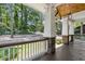 Spacious front porch with stone and wood accents, offering a relaxing outdoor space at 4642 Orchid Dr, Pine Lake, GA 30072