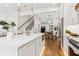 Stylish kitchen featuring a marble island, modern pendant lights, stainless steel appliances, and open layout at 4642 Orchid Dr, Pine Lake, GA 30072