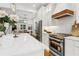 Well-lit kitchen with an island, stainless steel appliances, and a seamless transition to the dining area at 4642 Orchid Dr, Pine Lake, GA 30072