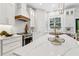 Modern kitchen features white cabinets, marble countertops, stainless steel appliances, and a stylish range hood at 4642 Orchid Dr, Pine Lake, GA 30072