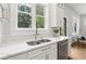 Bright kitchen features stainless steel appliances, white cabinetry, and a double sink below a large window at 4642 Orchid Dr, Pine Lake, GA 30072