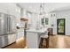 Well-lit kitchen with stainless steel appliances, island with bar seating, and an open layout to the outside at 4642 Orchid Dr, Pine Lake, GA 30072