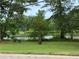 Beautiful scenery of the lake with picnic tables around it at 4642 Orchid Dr, Pine Lake, GA 30072