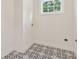 Functional laundry room with patterned tile flooring and natural light at 4642 Orchid Dr, Pine Lake, GA 30072