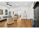 Open-concept living area with hardwood floors, modern furniture, and a view into the dining and kitchen areas at 4642 Orchid Dr, Pine Lake, GA 30072
