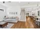 Expansive living area features hardwood floors, modern furnishings, and seamless access to kitchen and dining space at 4642 Orchid Dr, Pine Lake, GA 30072