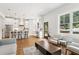 Open-concept living room showcases hardwood floors, a modern kitchen, and bright, airy atmosphere at 4642 Orchid Dr, Pine Lake, GA 30072
