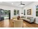 Bright and airy living room featuring hardwood floors and neutral decor with access to the back deck at 4642 Orchid Dr, Pine Lake, GA 30072