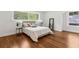 Serene main bedroom features hardwood floors, two windows, and a mirror for a restful retreat at 4642 Orchid Dr, Pine Lake, GA 30072