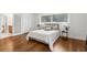 Well-lit bedroom features hardwood floors, ample natural light, and an en-suite bathroom with sliding door at 4642 Orchid Dr, Pine Lake, GA 30072
