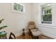 Cozy home office area with natural light, wood floors, and comfortable chair at 4642 Orchid Dr, Pine Lake, GA 30072