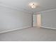 This bedroom showcases neutral walls, plush carpeting, and a walk-in closet, offering ample space and comfort at 687 Sunstone Ln, Lawrenceville, GA 30043