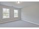 Cozy bedroom with plush carpeting, neutral walls, and large windows, perfect for relaxation and rest at 687 Sunstone Ln, Lawrenceville, GA 30043