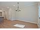 Dining room with stylish chandelier lighting and wood-look flooring at 687 Sunstone Ln, Lawrenceville, GA 30043