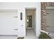 Close-up of townhouse entry, highlighting the door frame, brick accents, and address number at 687 Sunstone Ln, Lawrenceville, GA 30043