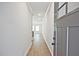 Inviting foyer with a long hallway, light hardwood floors and neutral paint scheme at 687 Sunstone Ln, Lawrenceville, GA 30043