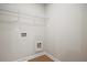 A dedicated laundry area with utility connections and overhead shelving at 687 Sunstone Ln, Lawrenceville, GA 30043