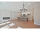 Spacious living room featuring a modern fireplace and a kitchen island with pendant lighting at 687 Sunstone Ln, Lawrenceville, GA 30043