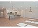 Spacious living area showcasing hardwood floors, a kitchen island, stainless appliances and a dining area at 687 Sunstone Ln, Lawrenceville, GA 30043