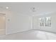 Spacious bedroom featuring neutral carpet, modern lighting, and a bright window at 695 Sunstone Ln, Lawrenceville, GA 30043