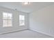 Inviting bedroom with carpet, contemporary lighting, and two bright windows at 695 Sunstone Ln, Lawrenceville, GA 30043