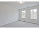 Cozy bedroom with soft carpeting, modern lighting, and a view from its bright windows at 695 Sunstone Ln, Lawrenceville, GA 30043