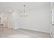 Bright dining room features wood floors, modern chandelier, and neutral paint, ready for personalization at 695 Sunstone Ln, Lawrenceville, GA 30043