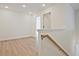 Hallway features wood floors, neutral paint, and lots of natural light at 695 Sunstone Ln, Lawrenceville, GA 30043