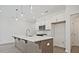 Kitchen island with a sink, white countertop, and stainless steel microwave at 695 Sunstone Ln, Lawrenceville, GA 30043