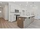 Kitchen island featuring quartz countertops, stainless microwave, and modern cabinetry, with easy access to other rooms at 695 Sunstone Ln, Lawrenceville, GA 30043