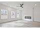 Bright living room featuring hardwood floors, large windows and a modern, sleek fireplace at 695 Sunstone Ln, Lawrenceville, GA 30043