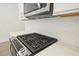 Stainless gas stove top in a modern kitchen at 695 Sunstone Ln, Lawrenceville, GA 30043