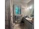 Cozy bathroom featuring a sink, toilet, patterned tile floor, and window providing natural light at 1164 Rogeretta Ne Dr, Atlanta, GA 30329